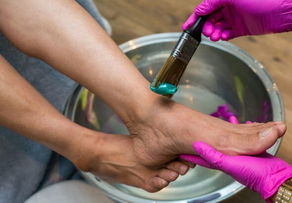 person holding brush and foot